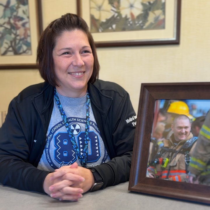 Tina Wehr sits at a table with a framed photo of her 44-year-old brother, Chris McCann