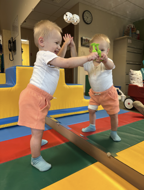 Male toddler in therapy room looking a himself in the mirror