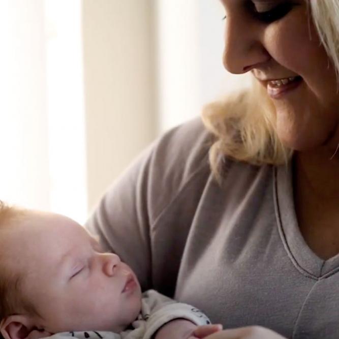 woman holding baby smiling