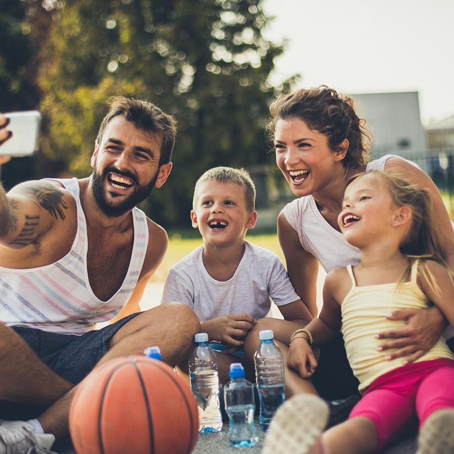 Family taking selfie at basketball court