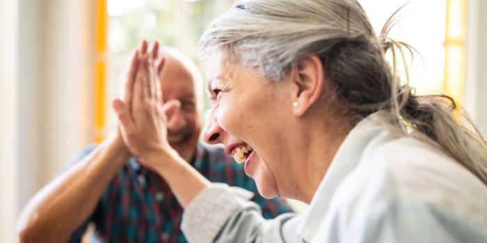 man and woman high fiving