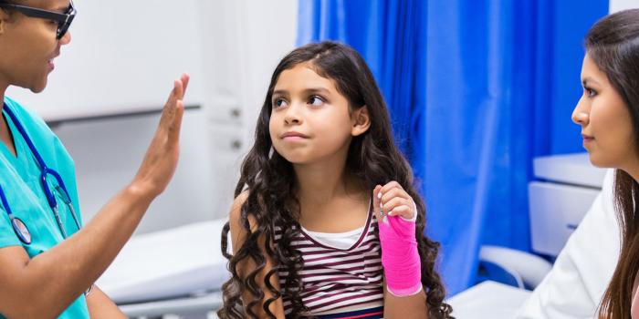 Nurse with child and mother patients in hospital room