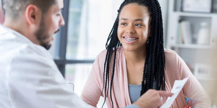 Teenage girl talking to a doctor