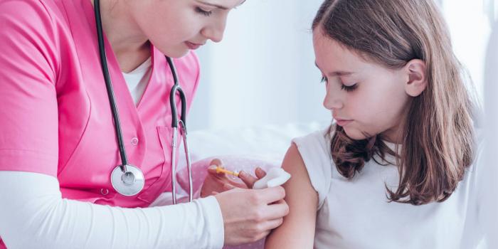 Nurse giving child a shot