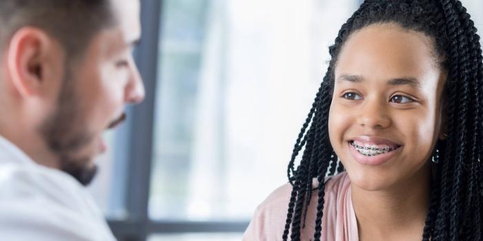 Teenage girl talking to a doctor