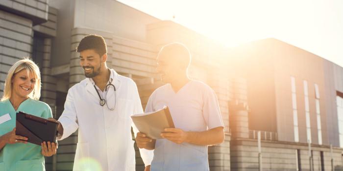 Group of clinicians walking outside building