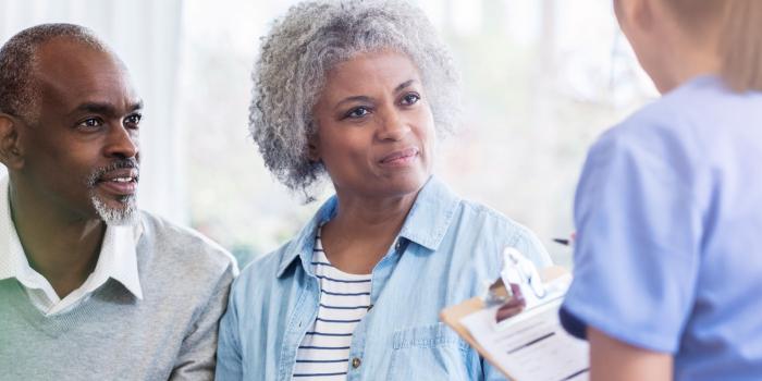 Couple talking to medical professional