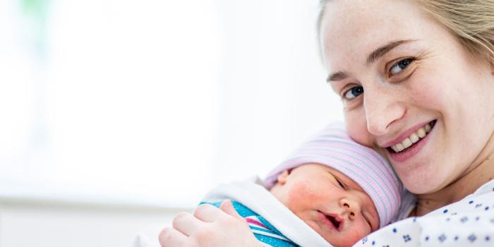 woman holding baby smiling