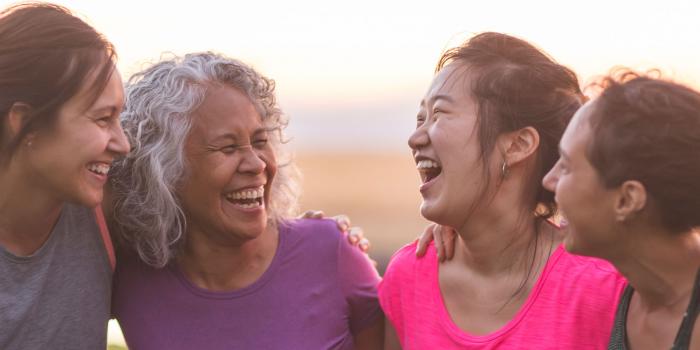 Four women laughing