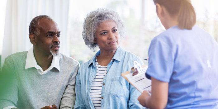 couple sitting with medical professional