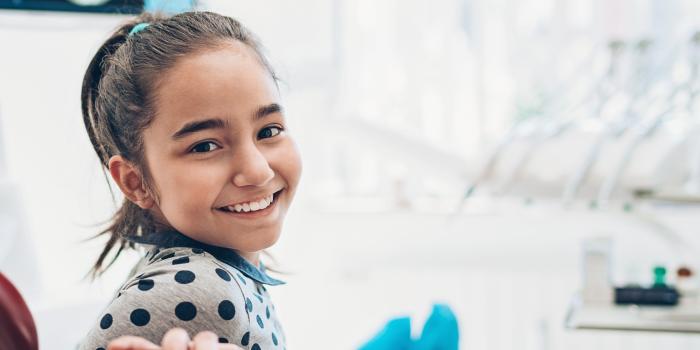 girl in hospital turning head and smiling