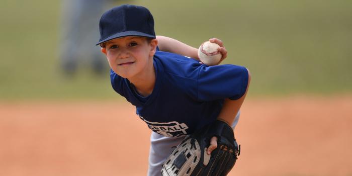 boy playing baseball bent over