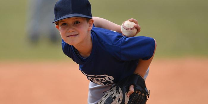 boy playing baseball bent over