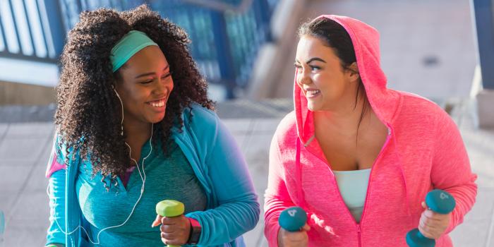 Two female teens walking up stairs