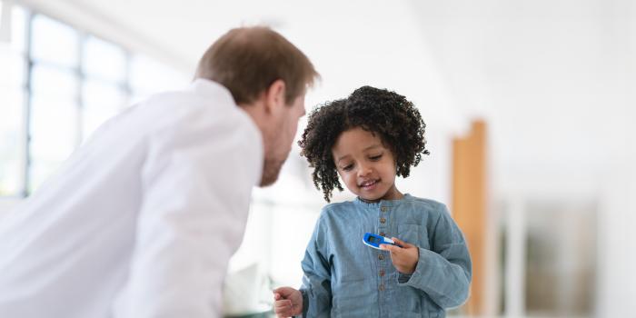 A Pediatric Endocrinologist educating a young diabetic patient, St. Christopher's Hospital for Children