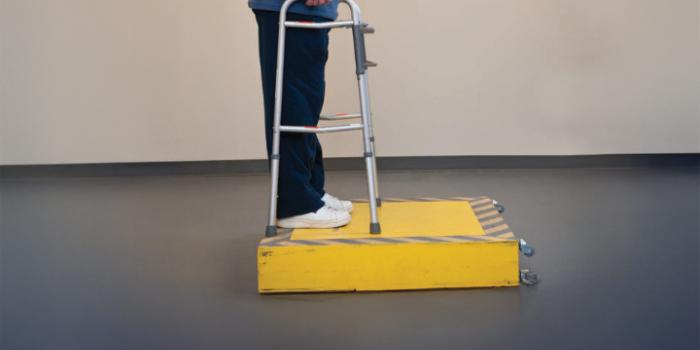 A person places the walker on curb first, making sure all four legs are solid. Step up with non-operated leg. Next, lean on walker and step up with operated leg.