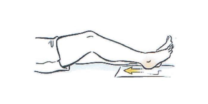 A person's leg is shown outstretched. Knee is bending by sliding the heel towards bottom. Heel is then dlid back to starting point to perform heel slides. 