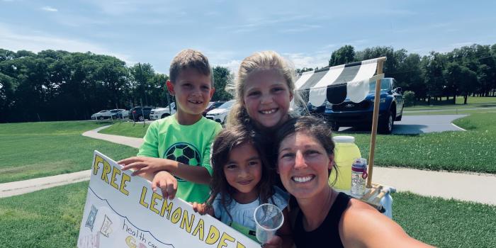 A mother and her young kids give out free lemonade while hosting a fundraiser on behalf of Reading Hospital Foundation
